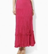 A cotton-silk maxi skirt is crafted in a crinkled silhouette for a unique breezy look.