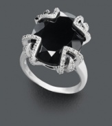 Not for the shy, this bold style makes a spectacular statement! Crafted in sterling silver, a large onyx center stone (12-1/3 ct. t.w.) is the focal point against a diamond dusted (1/10 ct. t.w.) prong setting. Size 7.