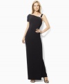 Crafted from sleek matte jersey with a modern cutaway shoulder, this elegant Lauren by Ralph Lauren evening dress is figure-flattering with ruching at the waist.