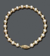 A polished pearl strand with a little extra shine. Bracelet features cultured freshwater pearls (5-1/2-6 mm) accented by shiny 14k gold beads and an ornate clasp. Approximate length: 7 inches.