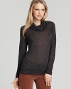 This slightly sheer ALTERNATIVE top boasts an ultra-drapey turtleneck, creating an elegant silhouette.