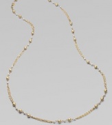 Strands of delicate golden chains gracefully connect textured golden beads and lustrous glass pearls in this elegant design that's long enough to double.Glass pearlsBrassLength, about 42Lobster claspImported