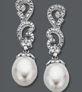 Update your jewelry box with a little glamour. These stunning, swirl-shaped drop earrings are adorned with round-cut diamonds (1/5 ct. t.w.) and cultured freshwater pearl drops (8 mm x 10 mm). Crafted in 14k white gold. Approximate drop: 1-1/4 inches.