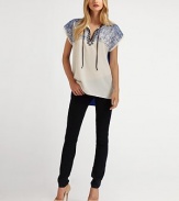 Geometric embroidery lends a unique touch of modern detail to this breezy shift, finished with a solid contrast back.Split T neckline with tie closureDropped shouldersPullover styleAbout 27 from shoulder to hemPolyesterDry cleanImported