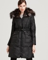 A luxurious fur collar lends glamour to this belted down coat from Dawn Levy.