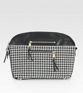 Graphic houndstooth fabric with leather trim and goldtone hardware.Top zip closureProtective metal feetTwo outside zip pocketsTwo inside open pocketsCotton lining14½W X 10½H X 3¼DMade in Italy