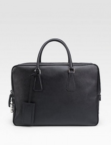 An elegant travel accessory is crafted in textured saffiano leather with top handles and a removable ID tag. Zip closureTop handlesID tagInterior zip pocketFully lined16W X 11H X 4LMade in Italy