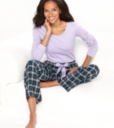 Relax in complete comfort in these pajamas by Nautica. The scoop neck top features an anchor logo on the lower corner of the shirt, while the roomy pants feature contrasting satin lining on the the inside of the elastic waistband.