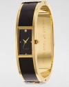 A chic enamel accented goldtone bangle timepiece. Quartz movementWater resistant to 3 ATMRectangular goldtone case, 16mm (0.6)Smooth bezelBlack dialDot hour markersSecond hand Enamel accented goldtone bangleImported