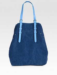 A casually chic style in denim-inspired canvas with luxurious leather trim.Adjustable shoulder straps, 2-14 dropSnap button strap closureOne inside open pocketOne detachable flashlight12W X 15H X 4DMade in Italy