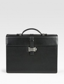 Single-gusset briefcase made of full-grain calfskin leather with a full, jacquard lining, ruthenium-plated metal accents and a unique lock closure.Top handleFlap front latch closureLeather14W x 10¼H x 4DMade in Italy