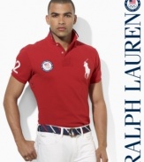 A trim-fitting short-sleeved polo shirt is rendered in breathable cotton mesh with bold country embroidery, celebrating Team USA's participation in the 2012 Olympics.