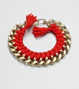 A chunky chain, with the look of a vintage ID bracelet, is modernized with bright red braiding with tassels and a fun paper-clip clasp.GoldplatedCottonLength, about 7.5Spring ring paper clip claspMade in France