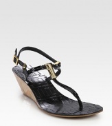 Patent leather t-strap with a natural cork wedge, goldtone T embellishment and adjustable straps. Cork-covered wedge, 2 (50mm)Patent leather upperLeather liningRubber solePadded insoleImportedOUR FIT MODEL RECOMMENDS ordering true size. 