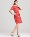 Punchy polka dots and a smock-detailed neckline impart a retro-chic vibe to this Tucker dress. A self tie belt finishes off the look with a curve-enhancing silhouette.