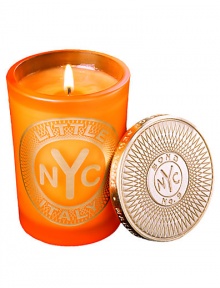 From a uniquely New York collection of scents, this unisex scented candle celebrates the lively charm of Little Italy.  · Blend of mandarin, sweet tangerine, Clementine and musk  · Made of the finest wax and wicks  · In sturdy, tinted glass container  · Gilt metal cap keeps scent from fading 