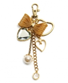 Take a bow. A bold mesh bow adorns Betsey Johnson's lovely, ladylike key chain. Featuring heart, chain and glass pearl charms, it's accented by glittering crystal details. Crafted in gold tone mixed metal. Includes a gift box. Approximate length: 6 inches.