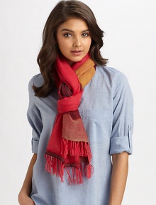 A semi-sheer, woven wrap in a colorblocked design with fringe trim.90% merino wool/10% acrylic80 X 26Hand washImported