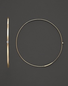 A graceful hoop in yellow gold with diamond accent and invisible closure to create a perfectly elegant orb to complement your most refined ensembles. Designed by Lana.