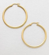 A simply classic, yet relevant design in radiant 18k gold. 18k goldLength, about 1.4Hinged post backMade in Italy