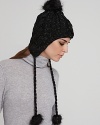 Keep cozy and look cool on the slopes or city streets in Eugenia Kim's cable-knit, pom pom accented cap.