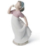 A young girl welcomes the first scent of spring in this charming handmade porcelain figure from Lladró.