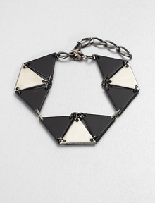 From the Facet Collection. Inspired by the mathematical genius of graphic artist M.C. Escher, this simple, strong linked triangle bracelet makes a striking statement.Powder-coated and antiqued brass and pewterLength, about 6-8 (adjustable)Lobster claspMade in USA