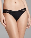 A stunning thong with sheer scalloped lace trim that accentuates the hips and legs, a subtle, yet dramatic effect.