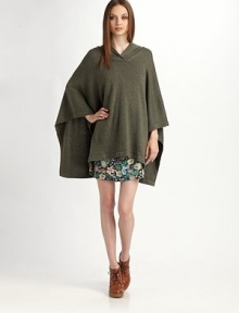 Cozy wool style with three-quarter poncho sleeves and a hi-low hem. Crossover neckline Three-quarter poncho sleeves Hi-low hem Merino wool Dry clean Imported