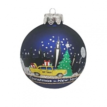 A snowy holiday scene, against a backdrop of the NYC skyline, is depicted on this glass ball ornament from Kurt Adler.