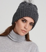 Exude cozy cool in this cable knit beanie topped with the all-essential pom pom from Eugenia Kim. Metallic thread lends modern, on-trend shine.