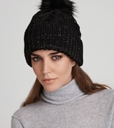 Exude cozy cool in this cable knit beanie topped with the all-essential pom pom from Eugenia Kim. Metallic thread lends modern, on-trend shine.