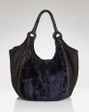 Elegant allure in carryall proportions. This Elie Tahari hobo gets it day-right in rich leather with polished details.