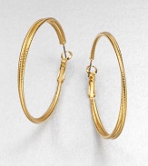 A simply chic piece with two textured rings, intertwined together in a radiant goldtone finish. GoldtoneLength, about 1.8Hinged post backImported 