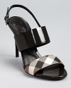 Polished in patent leather, Burberry's Powick sandals boast a flash of the brand's signature check print at the toe.