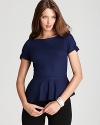 An asymmetric hem brings edge to Elie Tahari's peplum blouse, dressed up with grosgrain trim.