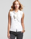 A frill-filled neckline and sleeve details add feminine flair to a Tory Burch sleeveless button front top.