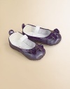 Dainty pearlized patent leather flats for baby with ruffle trim and elastic strap for a comfy, cozy fit.Adjustable elastic strapLeather upperCotton liningLeather soleImported