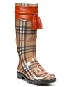 Leather trim lends fresh style to classic rain boots from Burberry.