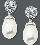 Sweet sophistication. Round-cut white topaz (7-3/4 ct. t.w.) and a cultured freshwater pearl (7 mm x 10 mm) form an elegant shape on these sterling silver drop earrings. Approximate drop: 3/4 inch.