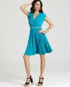 A chic belt adds polish to the Julie Dillon dress, featuring a crossover bodice and accordion-pleated skirt.