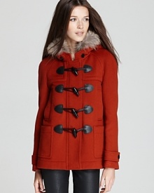 A plush fur-trimmed hood lends exotic appeal to a classic Burberry Brit Yorkdale coat, touting oversized toggles for a statement addition to your outerwear repertoire.