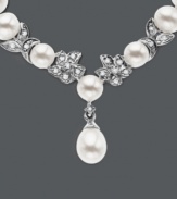 Cultured freshwater pearls (5.5-6mm) are paired with 14k white gold floral accents and shimmering diamond accents. Length measures 18 inches.