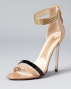 A chainmetal ankle strap and glossy patent leather add luxe details to Boutique 9's teetering pair of stiletto sandals.