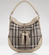 Let the British invade your closet in high style with Burberrry's check hobo. Shoulder the tassel-clad carryall to elevate daily looks--it loves crisp white blouses and loafer pumps.