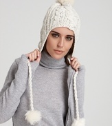 Keep cozy and look cool on the slopes or city streets in Eugenia Kim's cable-knit, pom pom accented cap.