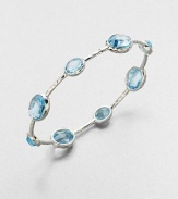 From the Rock Candy Collection. A graceful bangle of sculptural sterling silver is dotted with richly faceted ovals of dinsinctively hued blue topaz.Blue topazSterling silverDiameter, about 2.6Imported