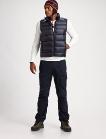 This smart puffer vest sports silvertone details and a lush down fill to protect you against all the elements.Mockneck collarSleevelessZip-front closureZippered side pocketsMesh interiorAbout 24½ from shoulder to hemNylonFill: 80% down/20% other feathersMachine washImported