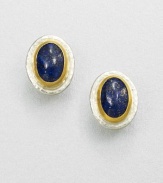 A beautiful, speckled lapis cabochon set in sterling silver and 24k gold. LapisSterling silver24k goldSize, about .9Post backImported 