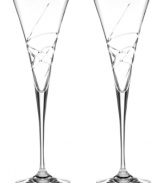 A fanciful cut pattern contrasts the timeless silhouette of Adorn crystal toasting flutes, featuring the exquisite craftsmanship of Lenox.